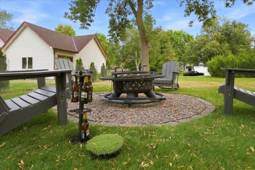 Firepit with a unique, in-ground beer bottle storage to keep your refreshments cool