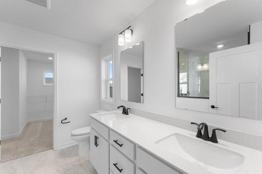 The en-suite bathroom has dual sinks to simplify any morning routine