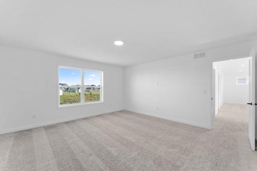 This spacious bedroom is complete with ample room for a king-sized bed