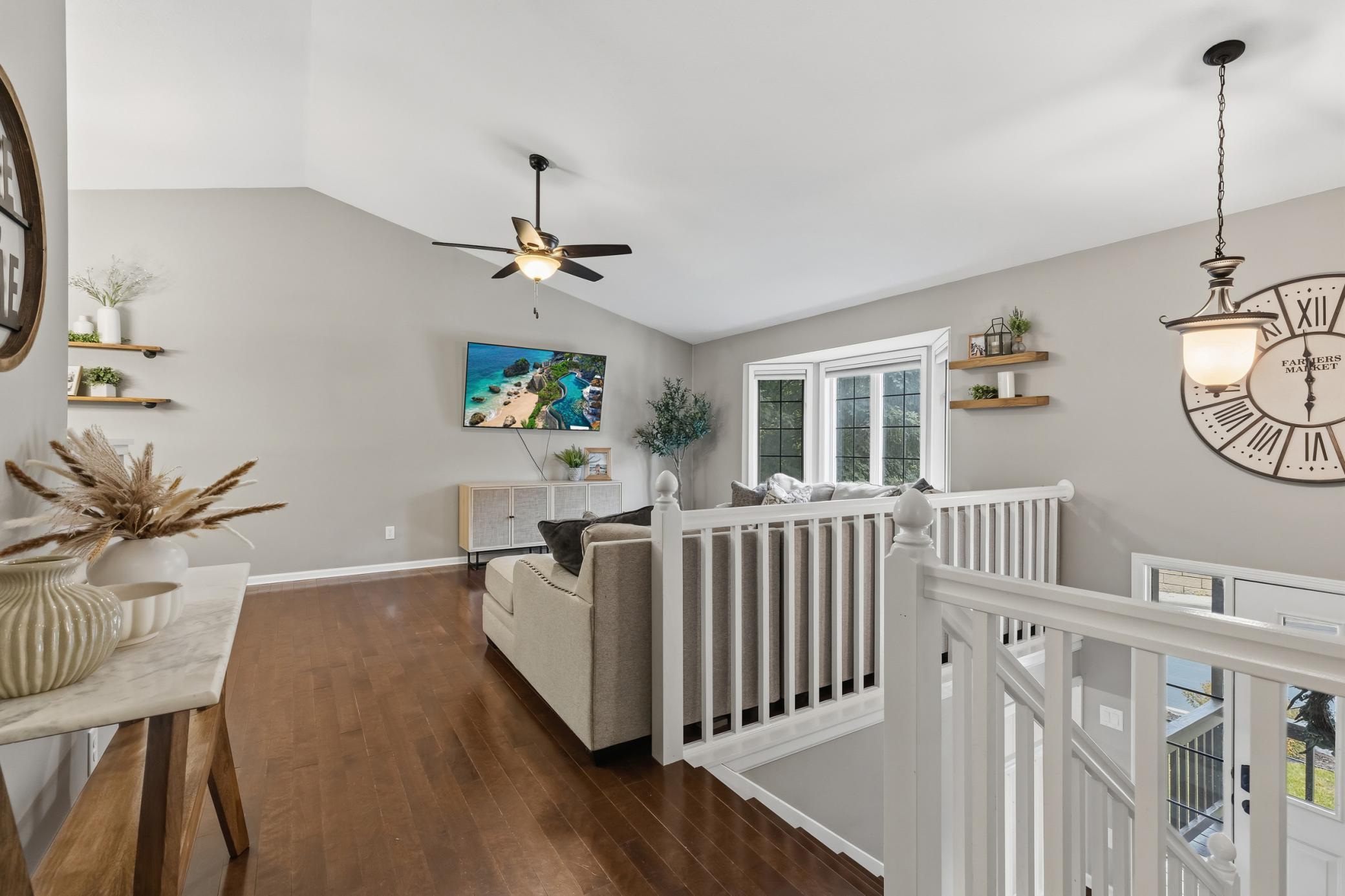 Living Room features vaulted ceilings and maple hardwood floors