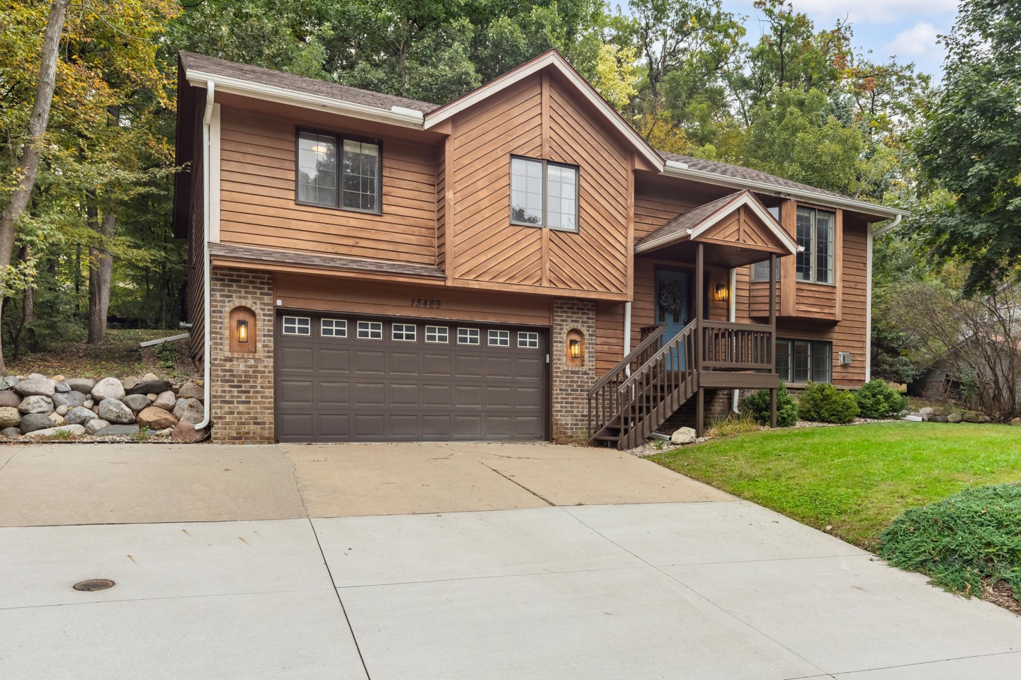 Tuck under 2 car garage with concrete driveway. Covered front entry