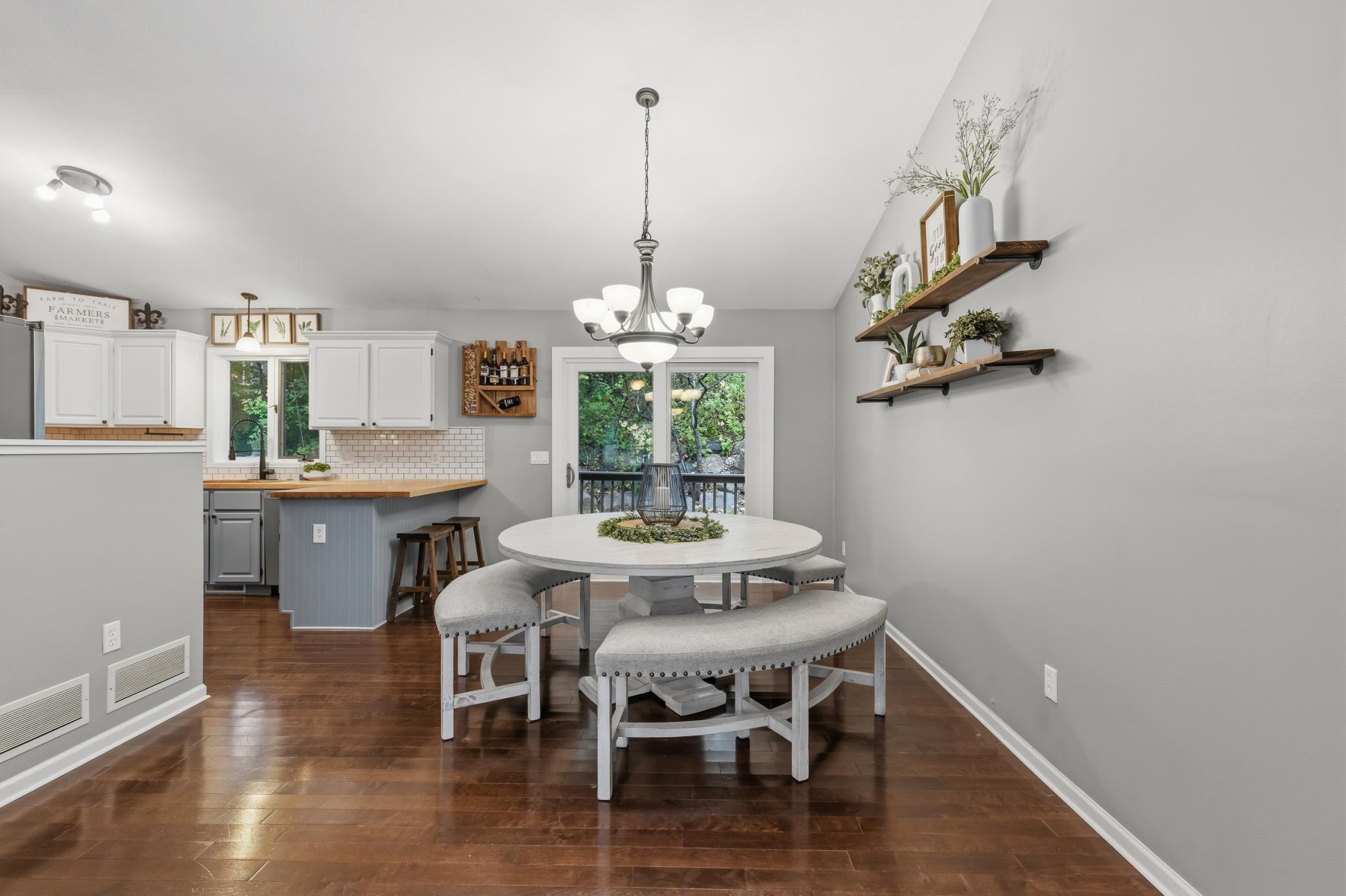 Dining Area features vaulted ceilings and a full glass patio door that offers access to the deck and property