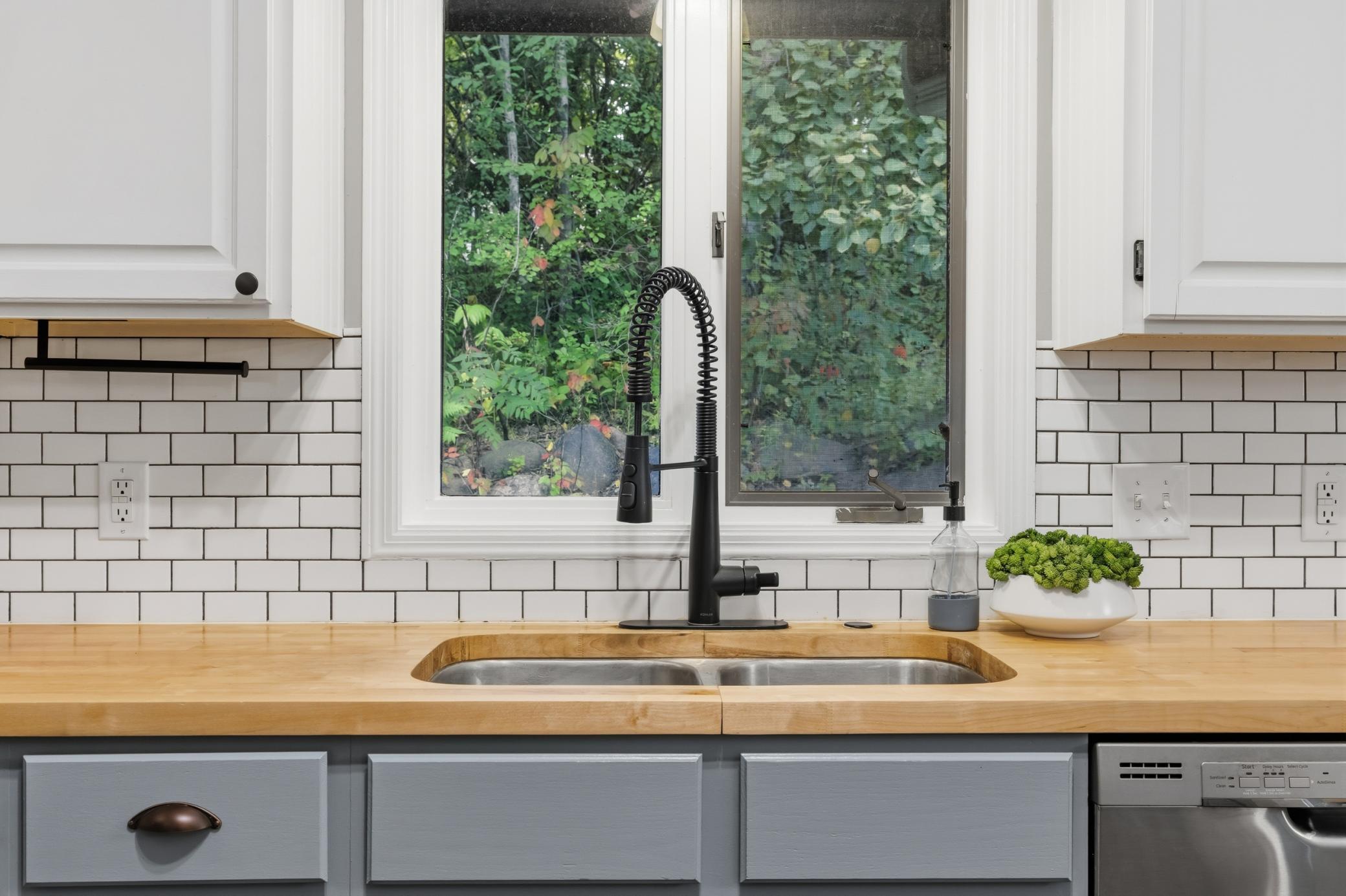 Butcher block countertops and classic subway tile backsplash