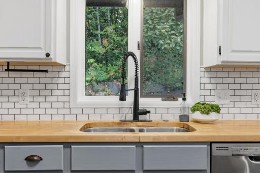 Butcher block countertops and classic subway tile backsplash