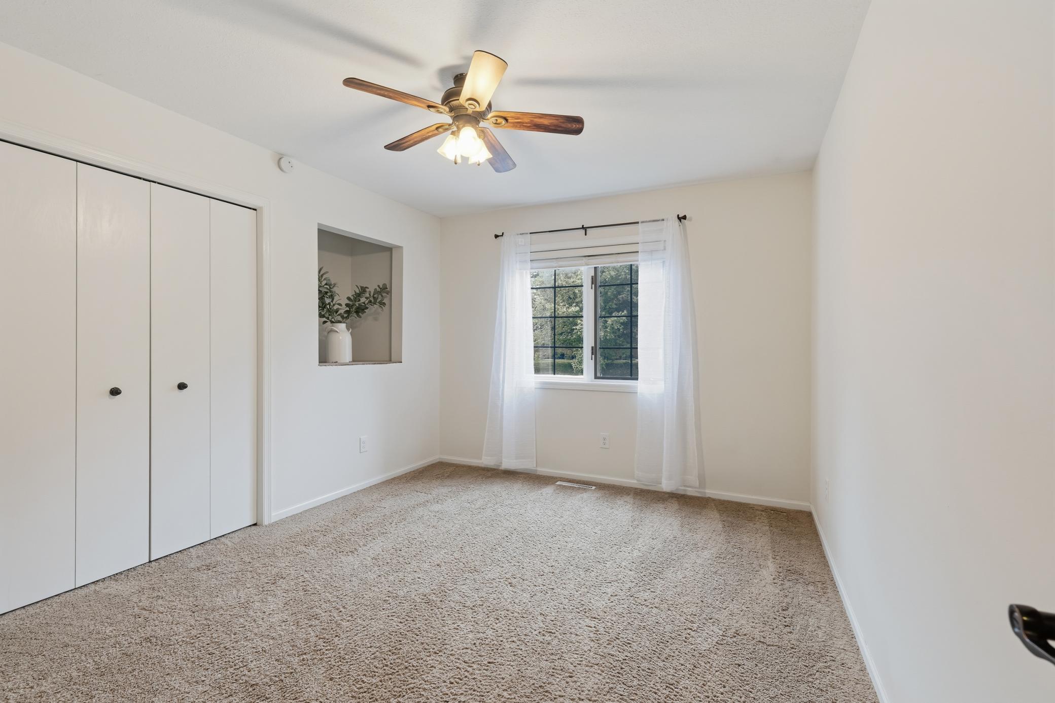 Bedroom 3 features ceiling fan and display niche