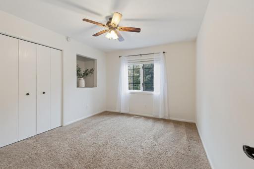 Bedroom 3 features ceiling fan and display niche