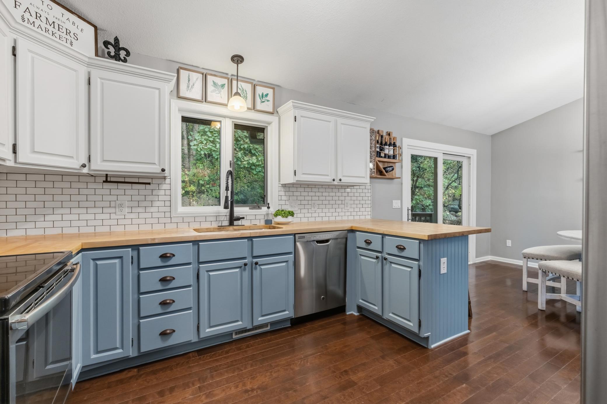 Stainless steel appliances include a french door refrigerator, range, dishwasher and microwave