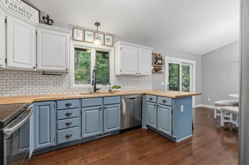 Stainless steel appliances include a french door refrigerator, range, dishwasher and microwave