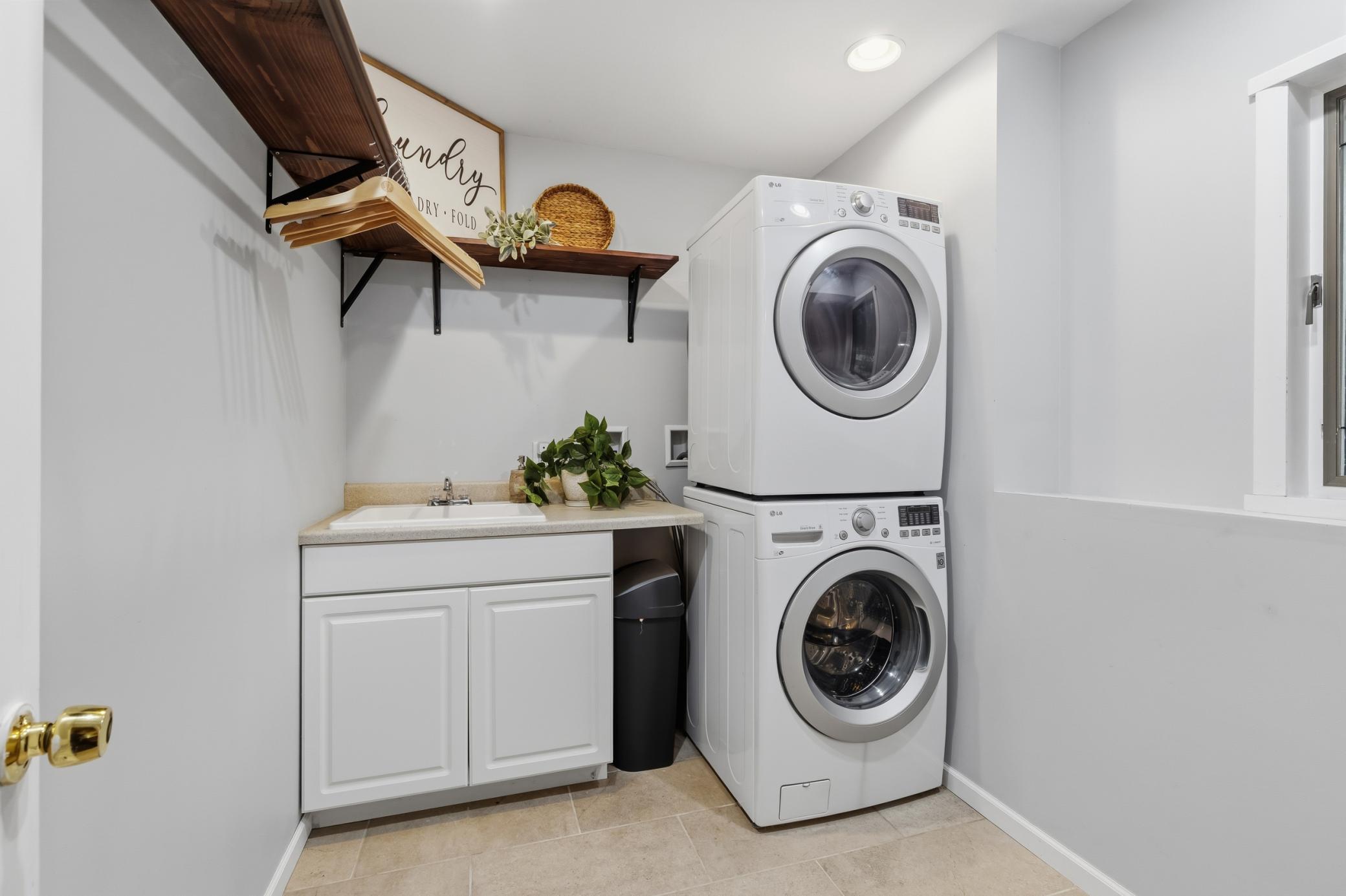 Laundry Room features an enameled cabinet with countertop and drop-in utility sink. Open and bright!