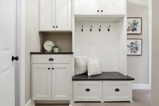 Custom mudroom built-ins & drop zone with charging station and hidden shoe storage