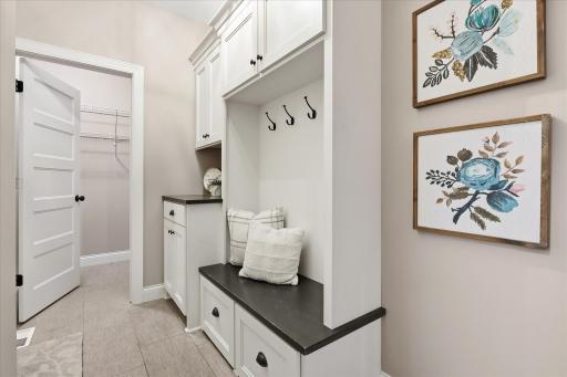 Functional back hall connects to a large walk-in storage closet