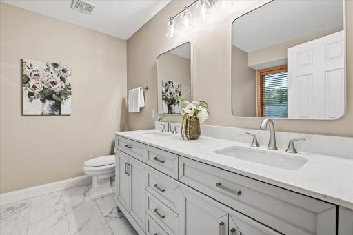 Renovated primary bath with double vanity & quartz countertops