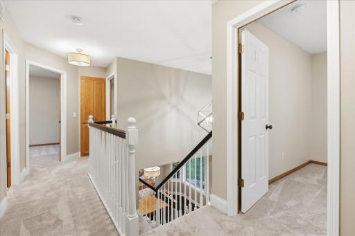 Open upper-level landing overlooking the soaring two-story foyer