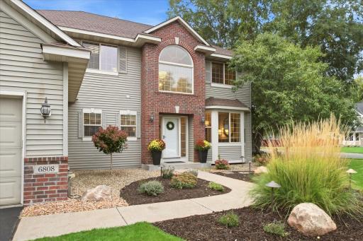 Professionally landscaped front entry welcomes you home