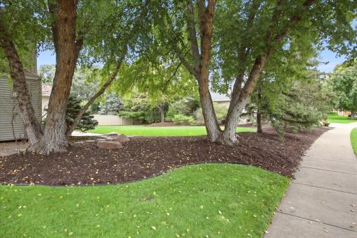 Beautiful mature trees & professional landscaping create a private, established setting