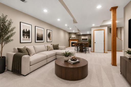 Spacious lower-level family room featuring recessed lighting, gas fireplace & plenty of room for relaxing, entertaining, or creating a game area. Virtually staged to illustrate the room’s potential
