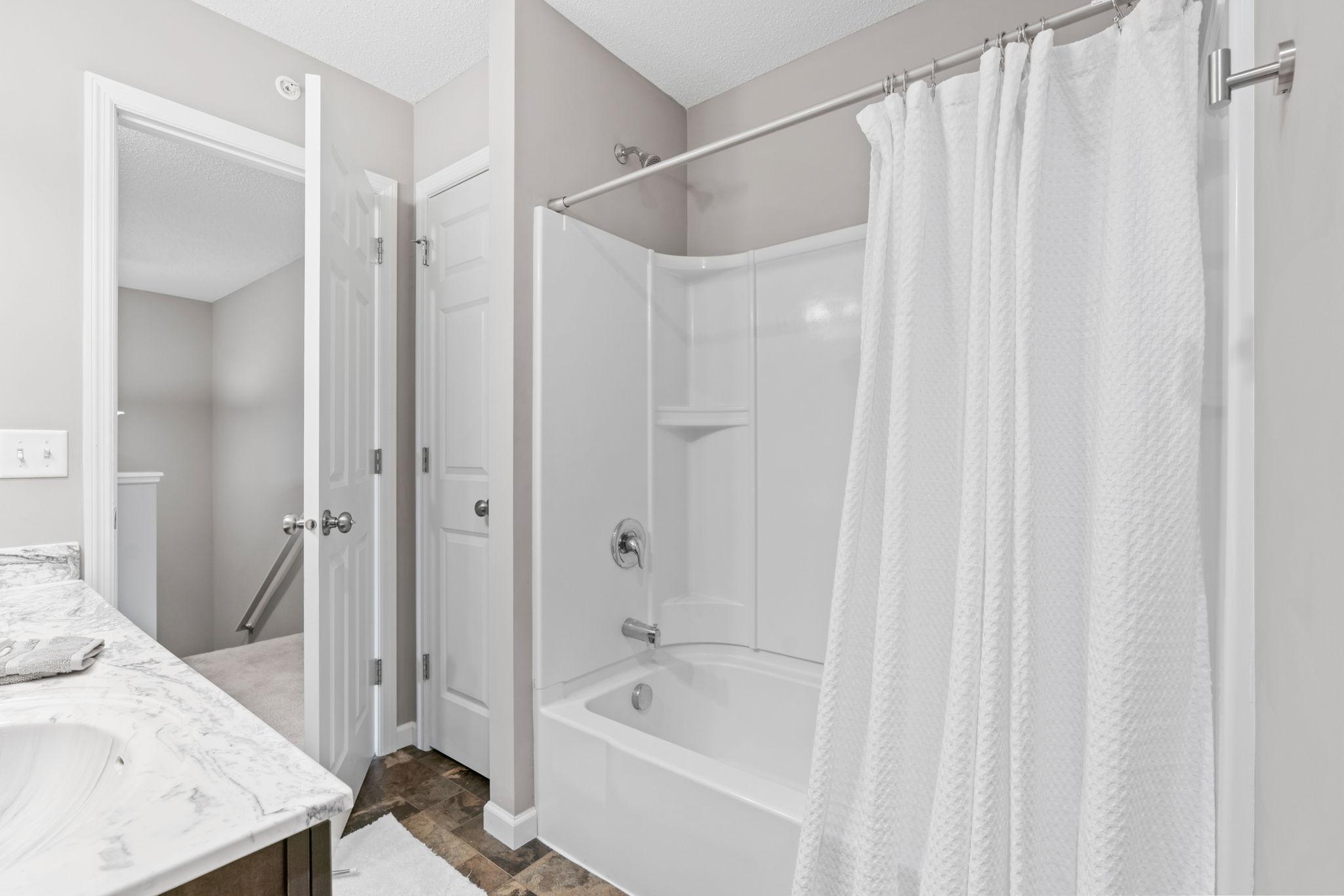 Reverse view of hall bath shows and additional linen closet