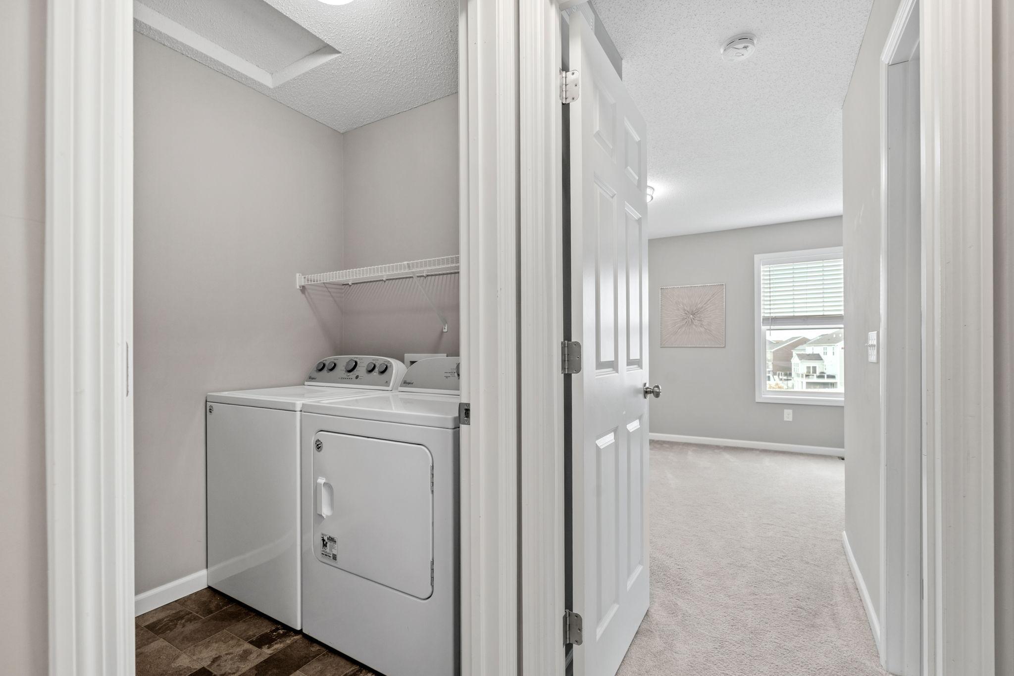 The laundry room is conveniently located upstairs with the bedrooms