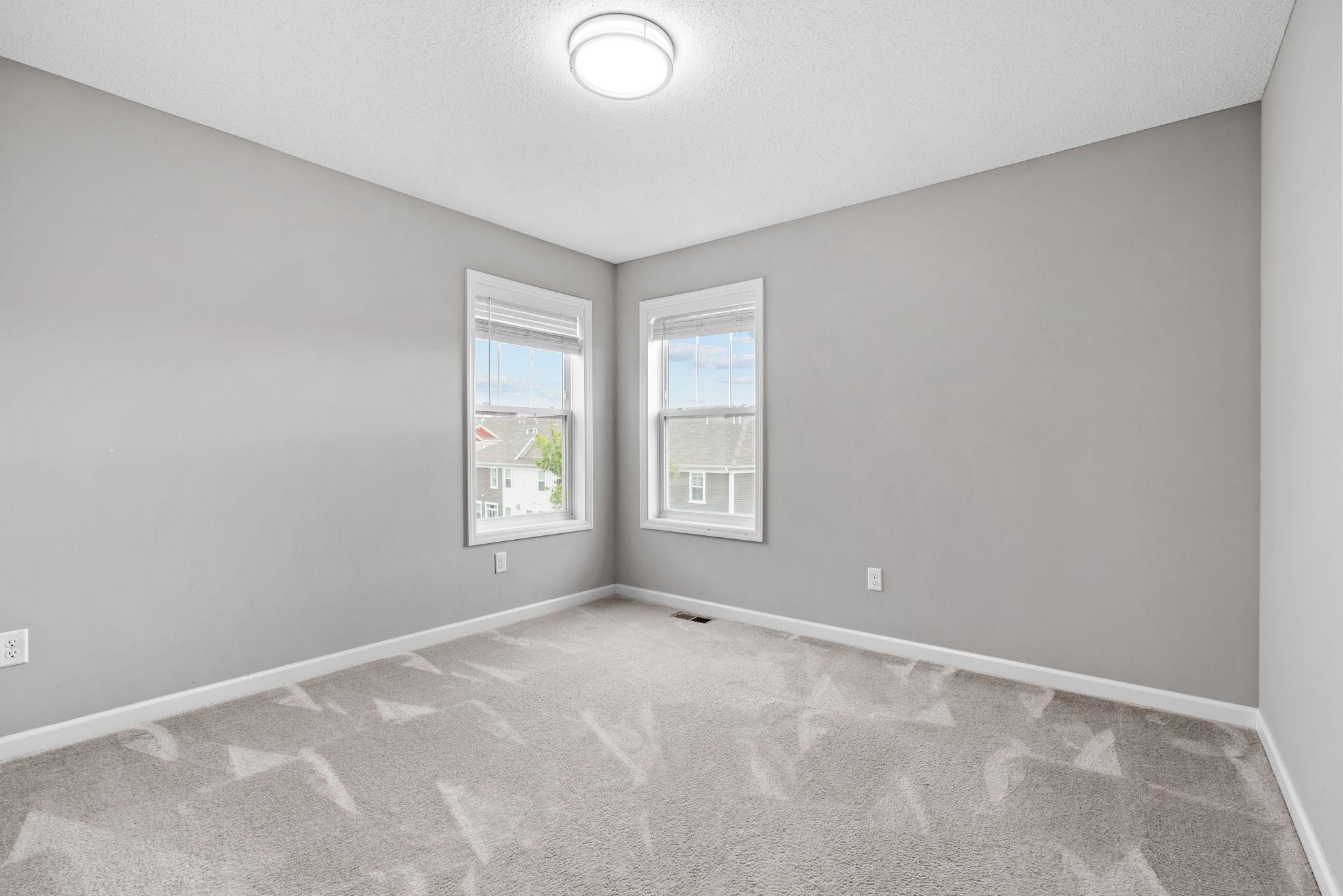 The 3rd bedroom has an extra window and measures 12 x 12. The windows look out to the side and rear of the home