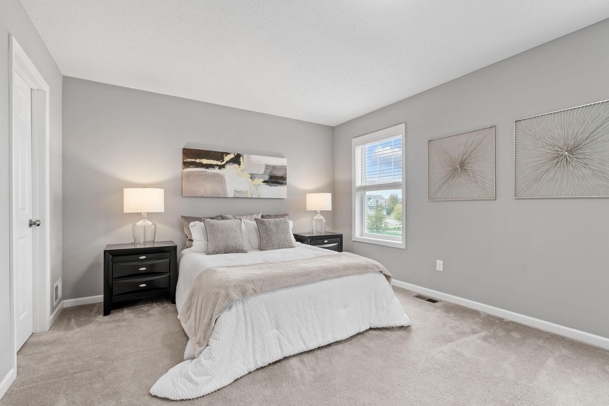 The primary bedroom is spacious with 2 closets, primary bathroom and windows to the front of the home
