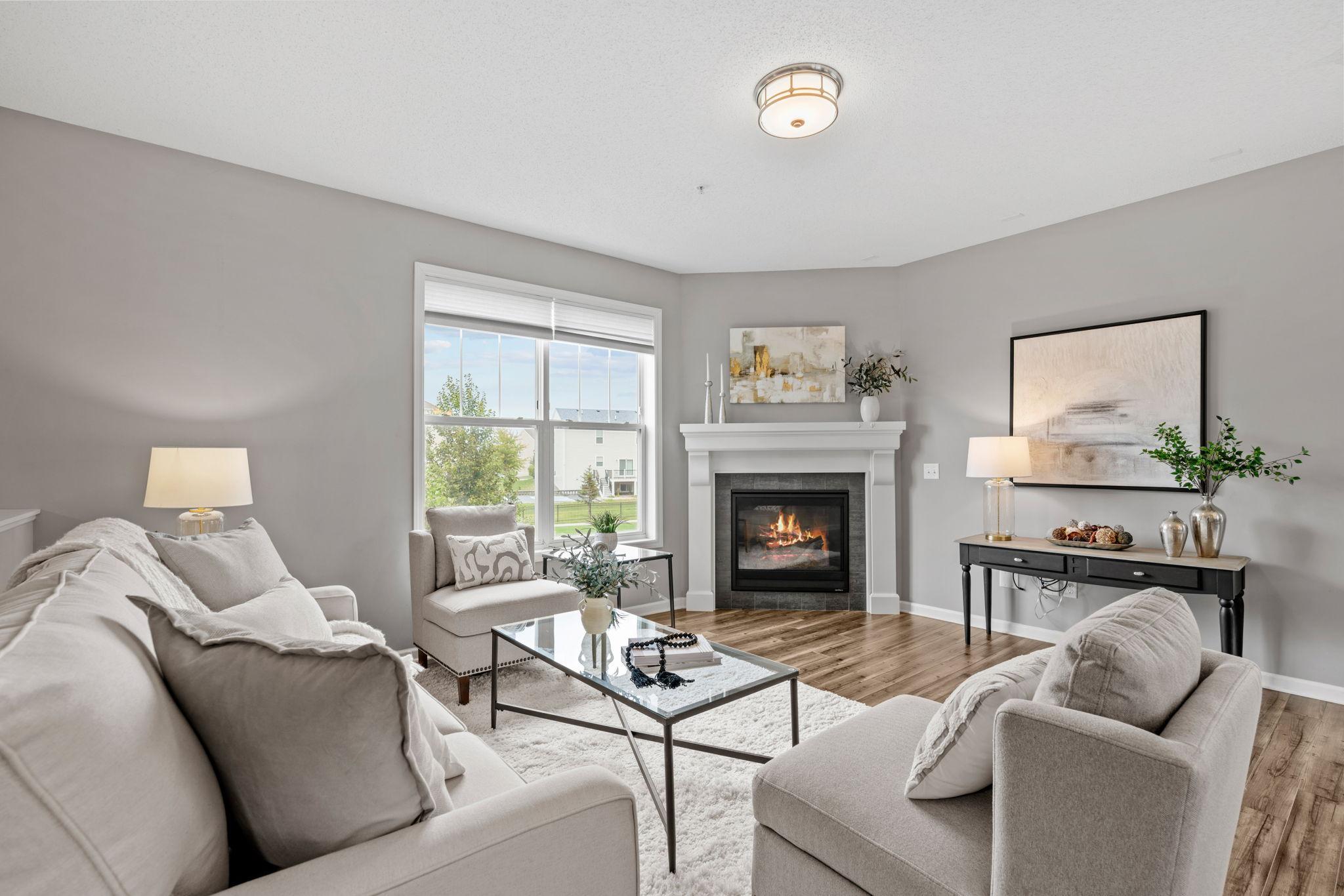 Once on the main level the high ceiling , LVP flooring and fireplace greet you