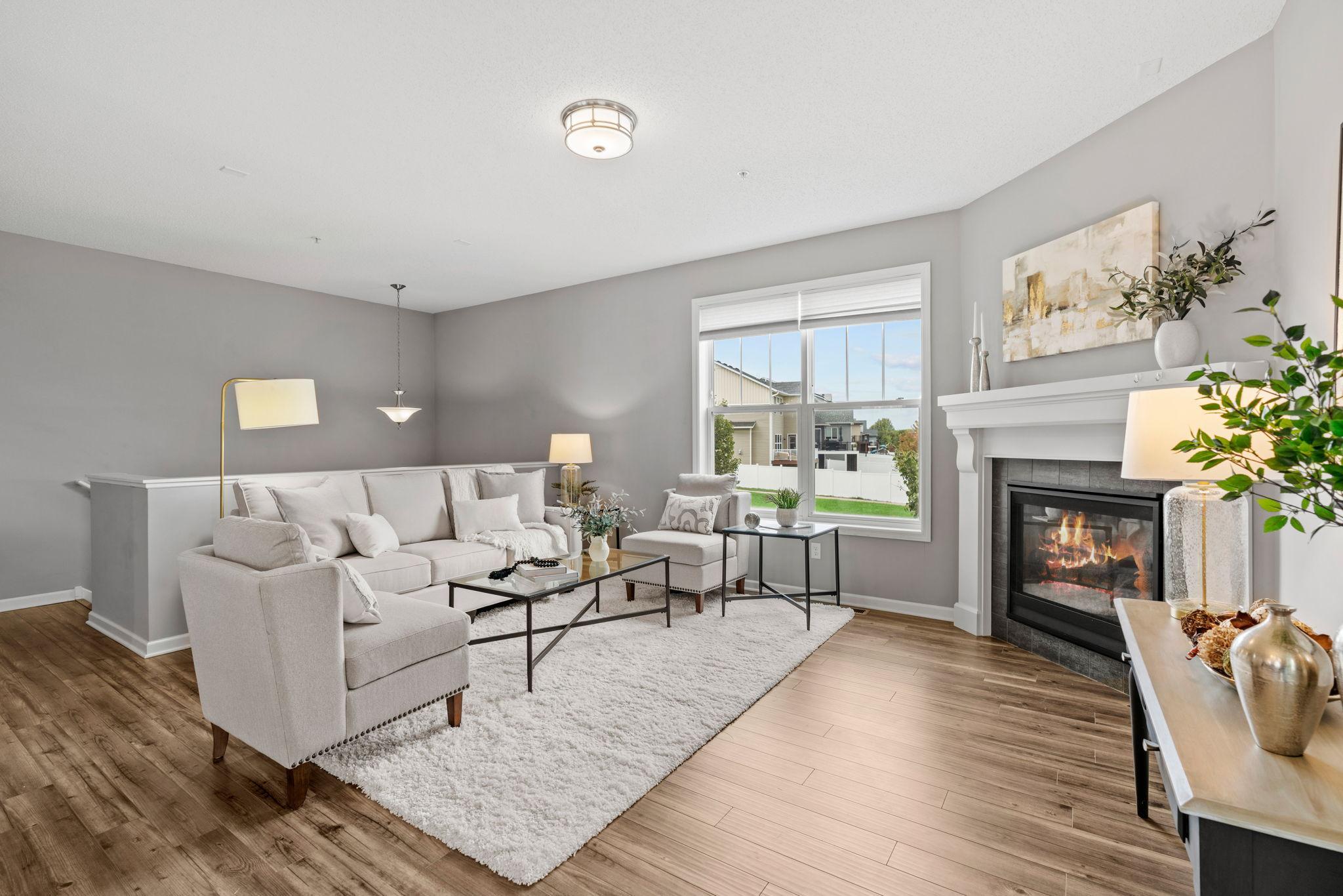 The main level living room has a gas fireplace and 9ft ceilings for those warm and cozy nights in