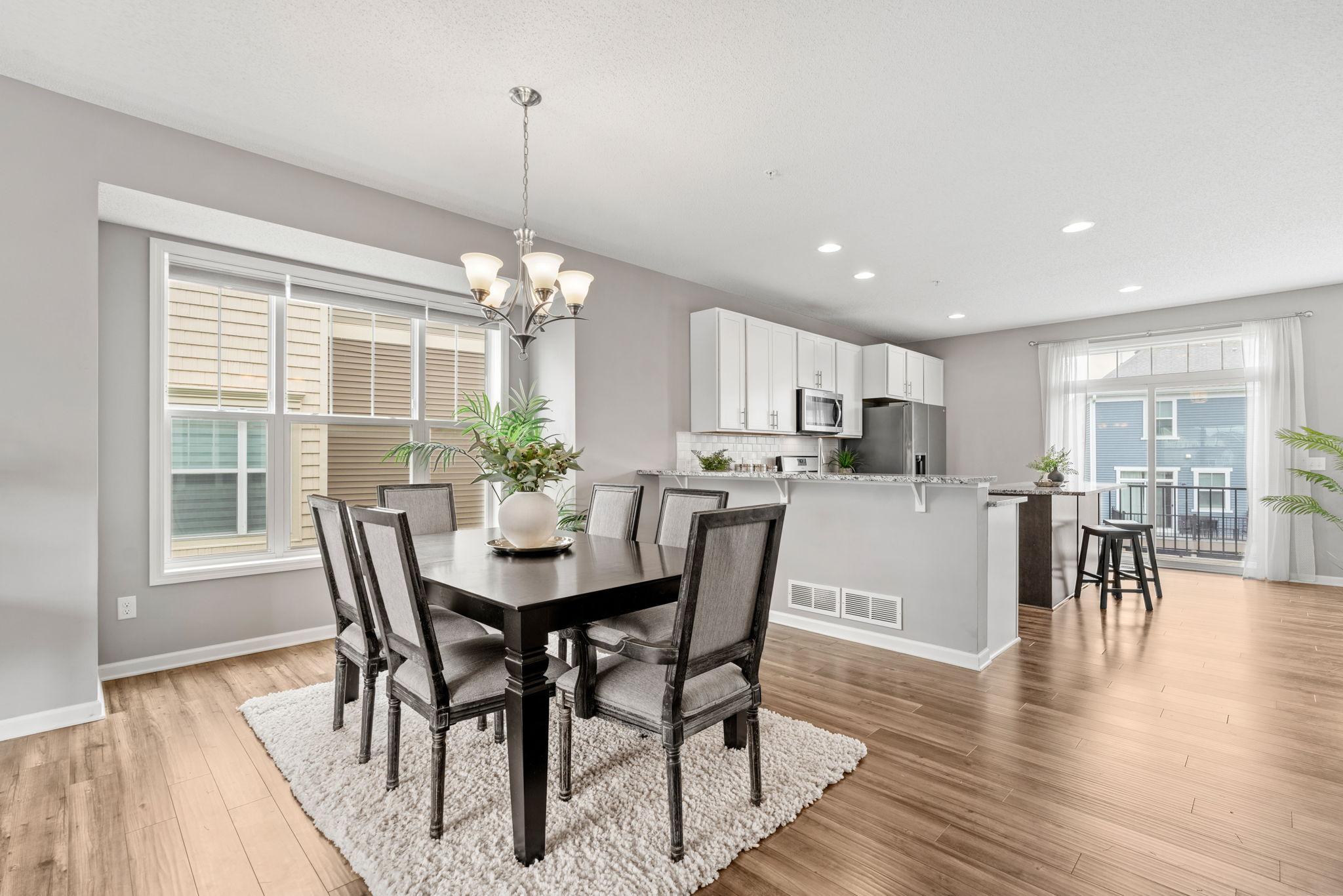 Dining room is convenient to the kitchen and perfect for meals with loved ones and friends. The extra window from being an end-unit allows extra light to stream in. Extra seating at the peninsula with bar stools