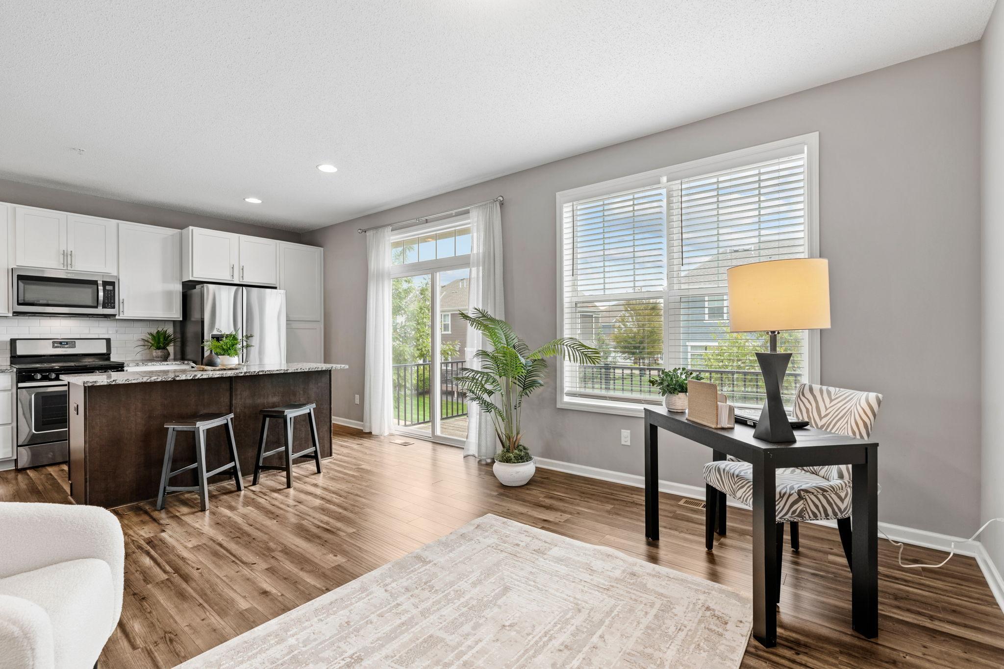 Reverse view of kitchen and flex space. The deck and sliding door is right of the kitchen and allows for extra light