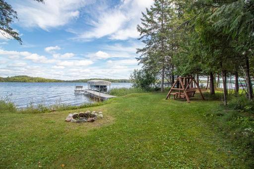 Flat level yard leads to a FANTASTIC hard sand beach that extends into the lake. Rate this a 10 for lake bottom!