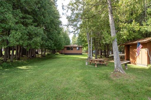 Perfectly LEVEL lot from the cabin to the lake. And bordered by beautiful White Cedars creating privacy!