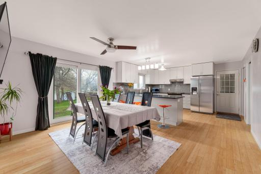 Open dining and kitchen layout with large windows bringing in natural light