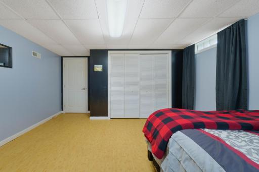 Lower level bedroom with triple-panel closet and plenty of storage