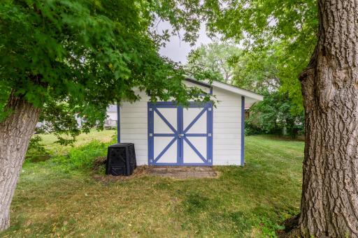 Storage shed with double doors for lawn and garden equipment