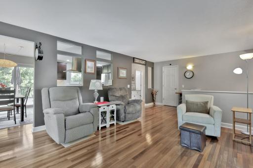 Upper level living room, openings in dividing wall into kitchen for an abundance of natural light.