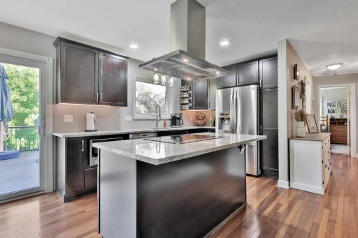 Updated kitchen with center island. cook top and central exhaust fan.