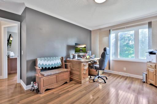 Larger lower level bedroom used as an office.d