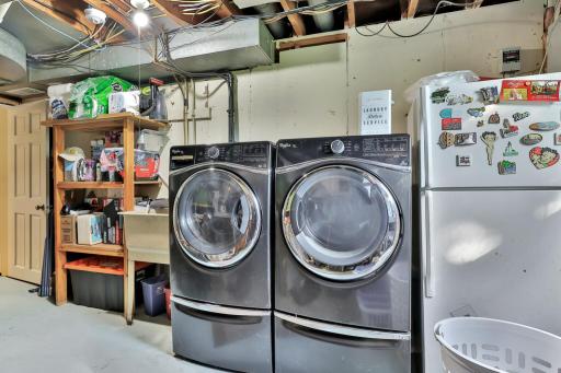 Laundry room with raised stainless washer and dtyer.