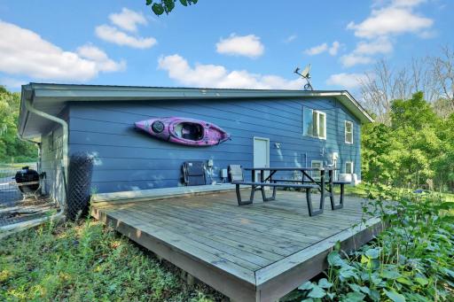 Additional wood deck behind the attached garage.