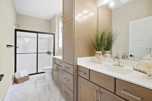 Double vanity sinks and heated bathroom flooring in main bath.