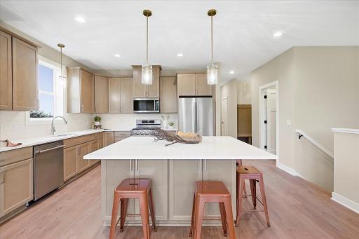 Large quartz center is just one of the many upgrades in this beautiful home.