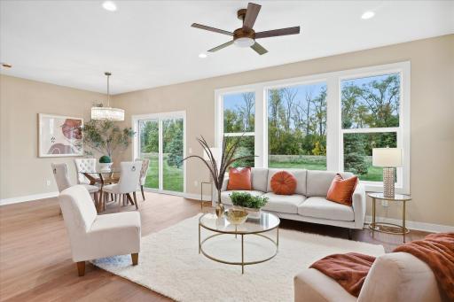 Large windows and patio door offers great site lines to the tree line and walking path directly behind the home.