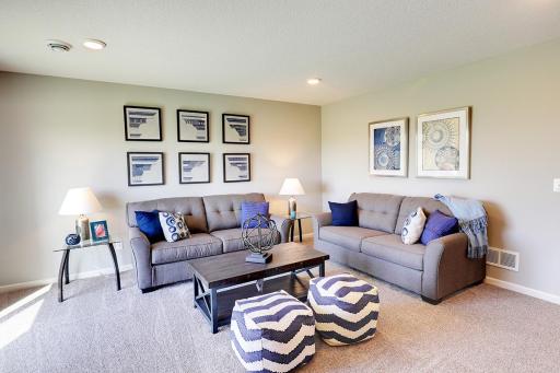 Finished lower level makes for a great entertaining space, or lounge area! Model home, color and finish will vary.