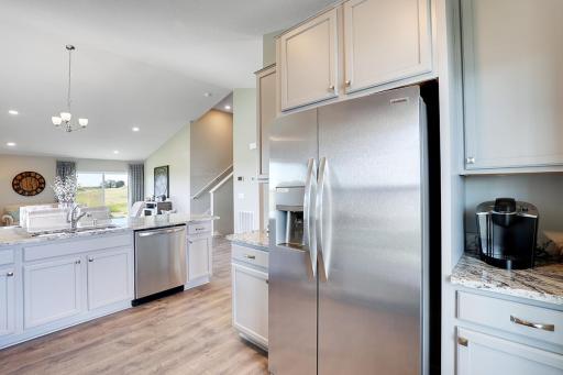 Stainless appliances, coffee nook and more storage! Model home, color and finish will vary.
