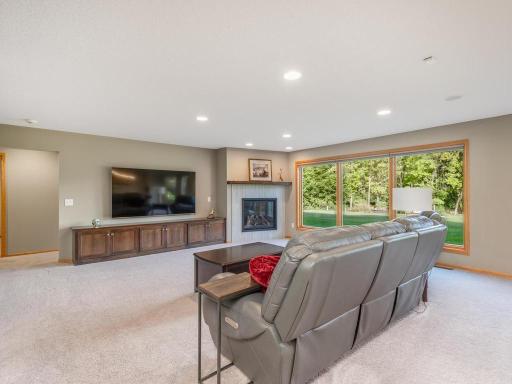 Family room features a gas fireplace, custom built-ins, and an expanse of windows with amazing views!