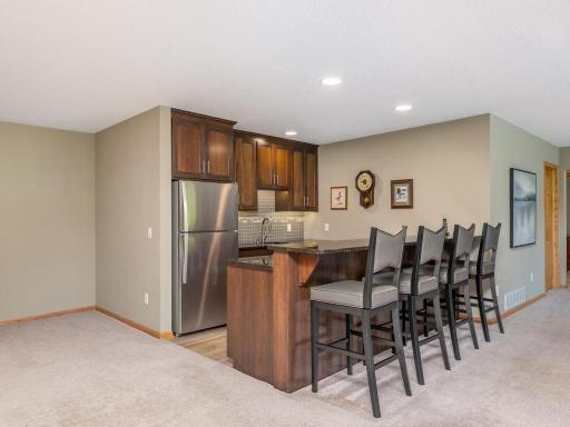 Adjoining Wet Bar to the Family Room & Amusement area compliments the space nicely and provides a wonderful gathering space in the lower level.