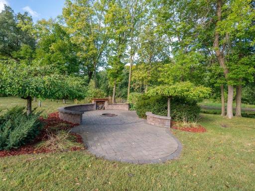Private river-side firepit paver patio area provides a wonderful gathering space throughout the changing seasons.