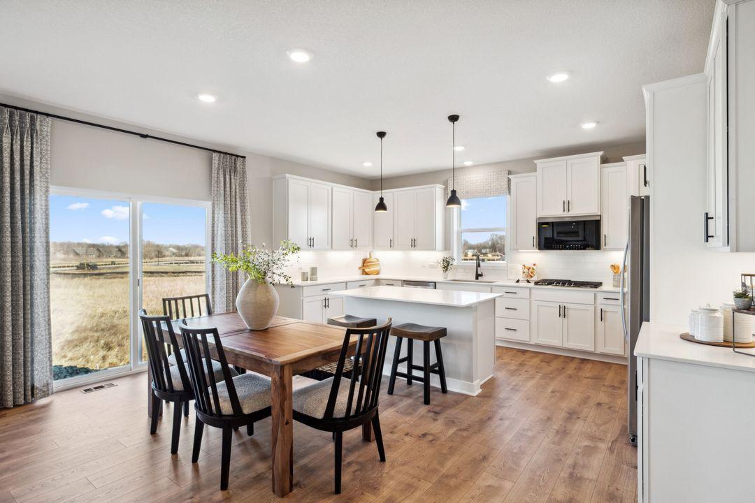 Open floor plan with huge walk in pantry, plus informal and formal dining area. Photo of a model home, color & options will vary.