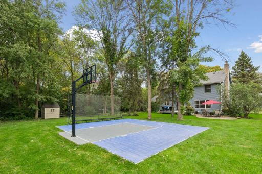 Backyard sport court offers year-round recreation and can be transformed into an outdoor skating rink in winter