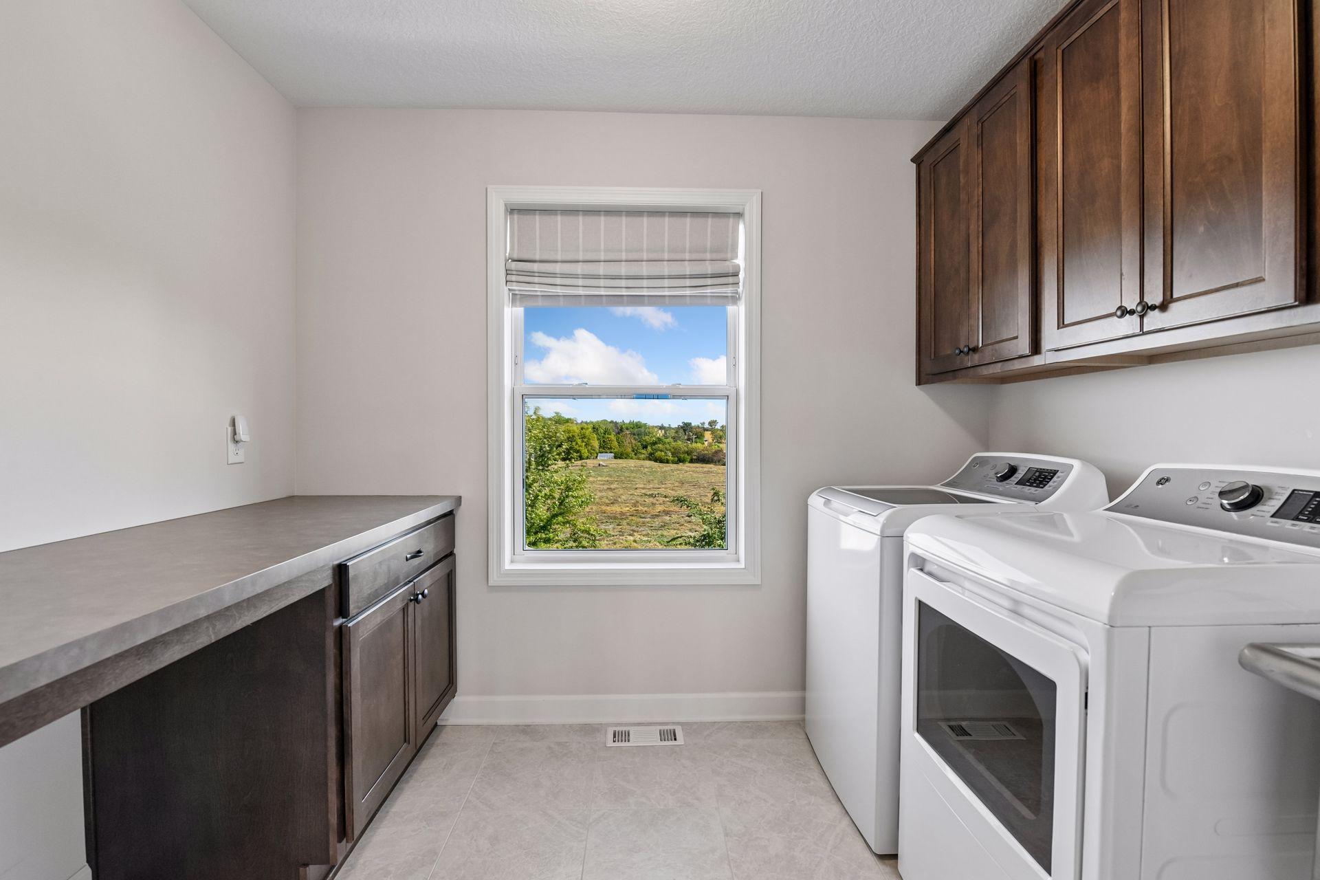 The Laundry Room completes the upper level with a folding counter, built-in cabinetry, a laundry sink and closet.