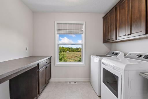 The Laundry Room completes the upper level with a folding counter, built-in cabinetry, a laundry sink and closet.